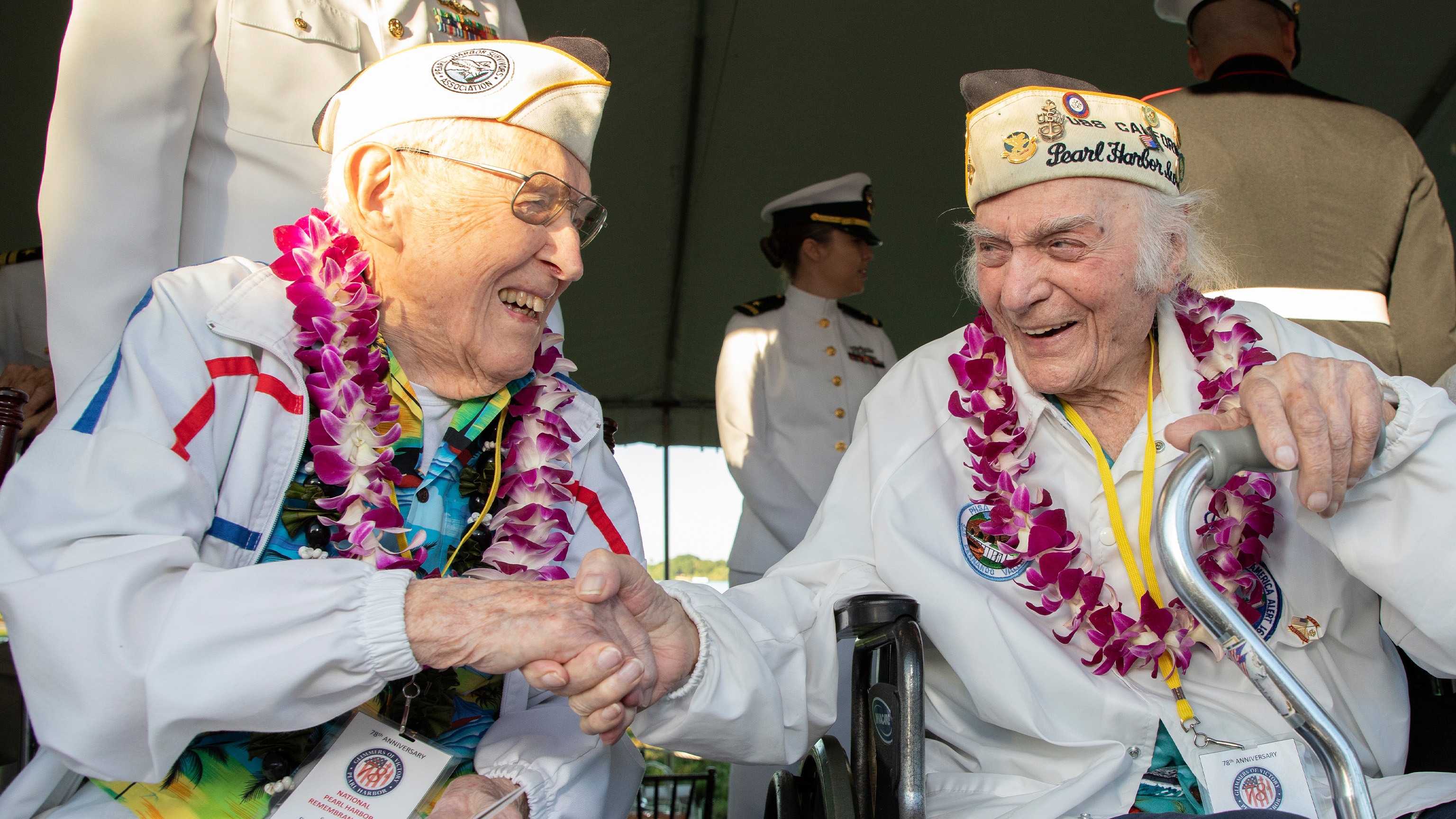 FILE - 100-year-old Veteran Warren Upton, from the USS Utah, left, with Navy Chief Joseph Mariani, right, at the Pearl Harbor National Memorial on Dec. 7, 2019 in Honolulu, Hawaii.