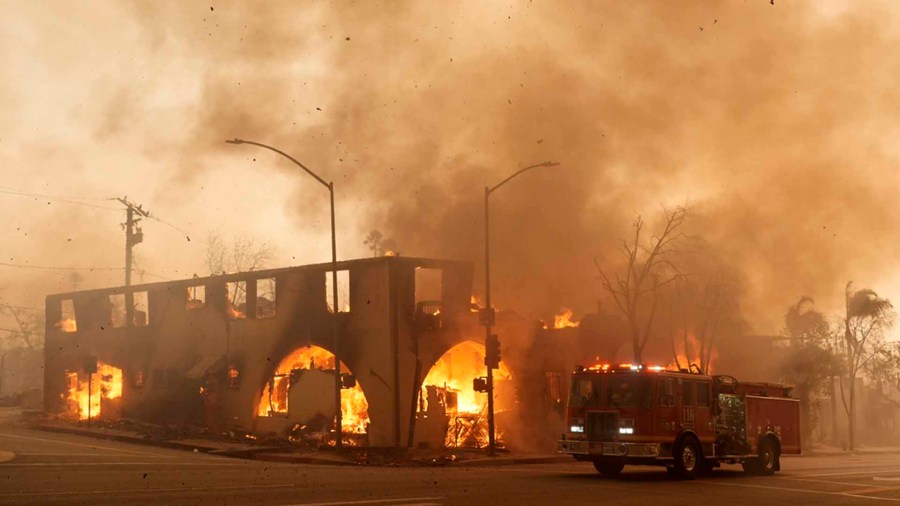 Smoke and debris fill the air as a structure on Lake Avenue burns.